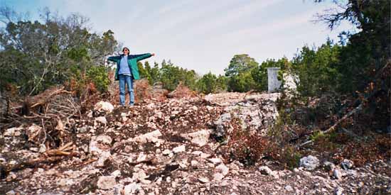 Jane is standing on a pile of rocks.